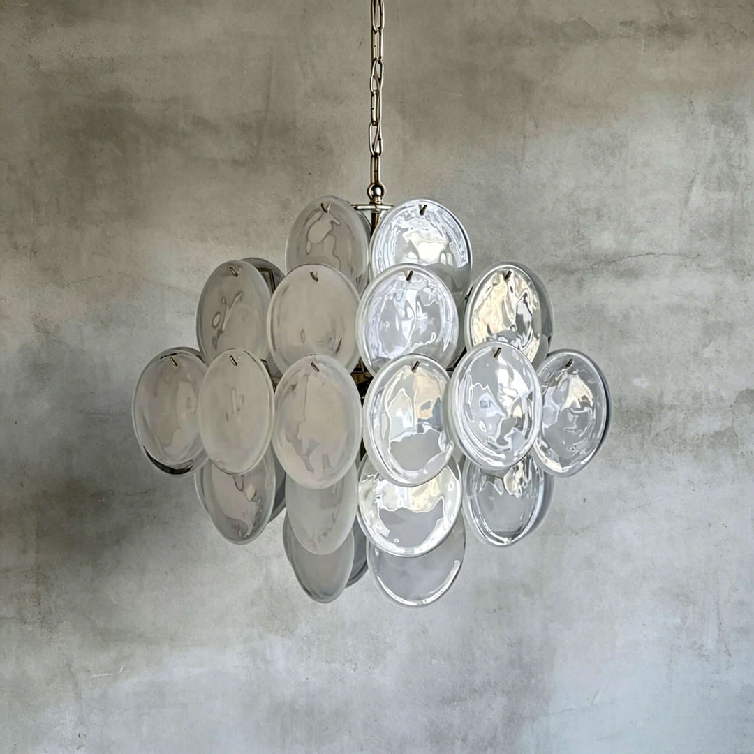 White Murano Disk Chandelier with clear textured glass discs against a gray concrete wall