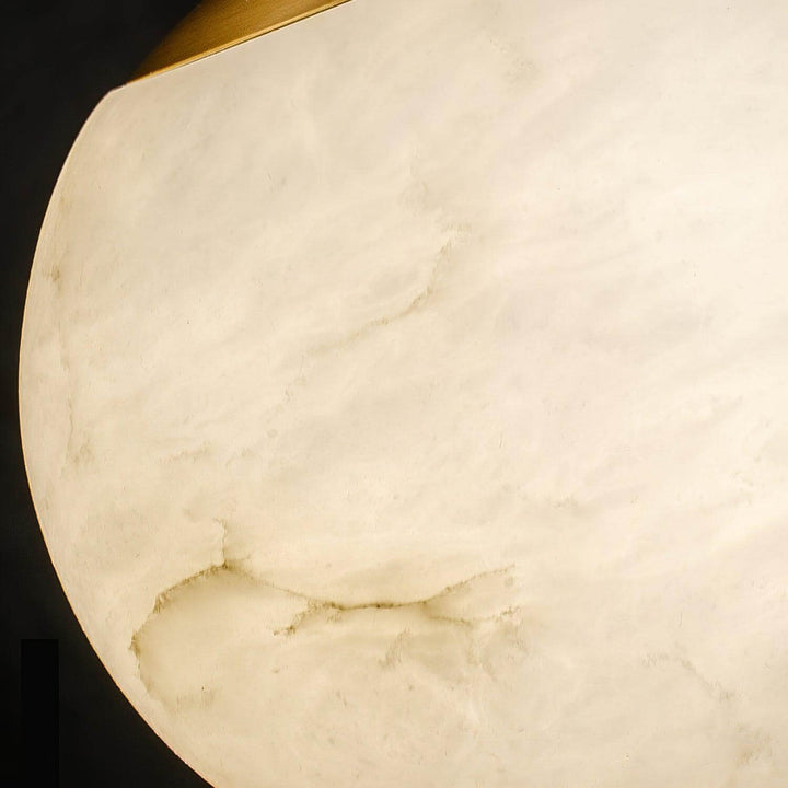 Close-up of the natural veining and warm illuminated texture of the Bosso alabaster globe shade
