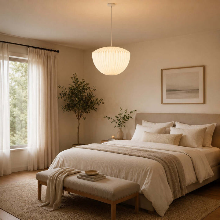 Bell-shaped Nelson Bubble pendant lamp casting soft light above a serene neutral bedroom