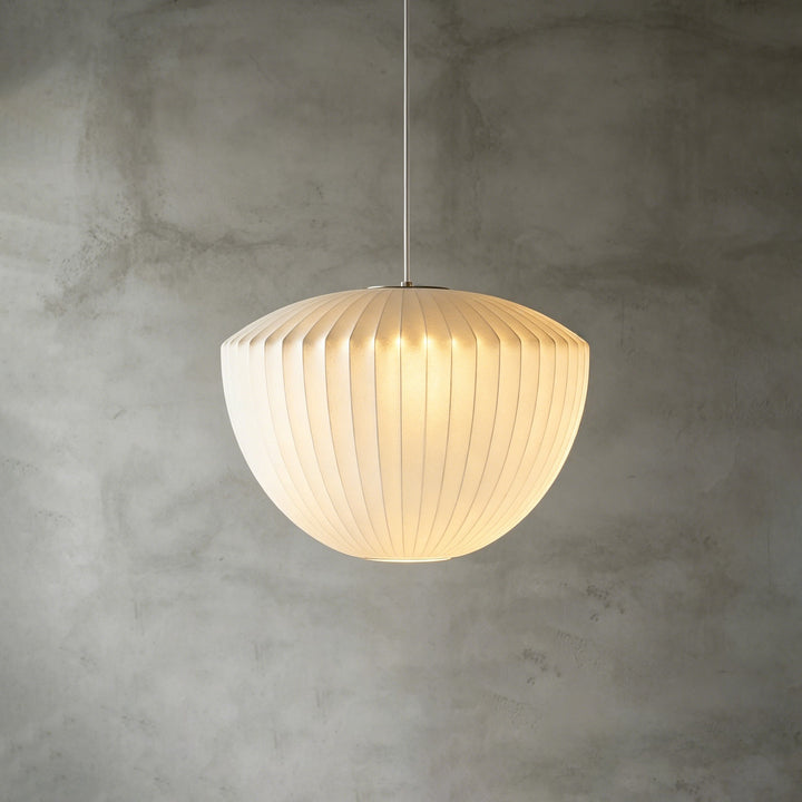 Bell-shaped Nelson Bubble pendant lamp with vertical ribs and a softly glowing white silk shade