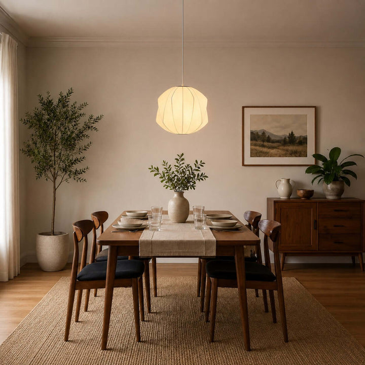 Faceted round Nelson Bubble pendant light above a rectangular dining table in a natural wood dining room