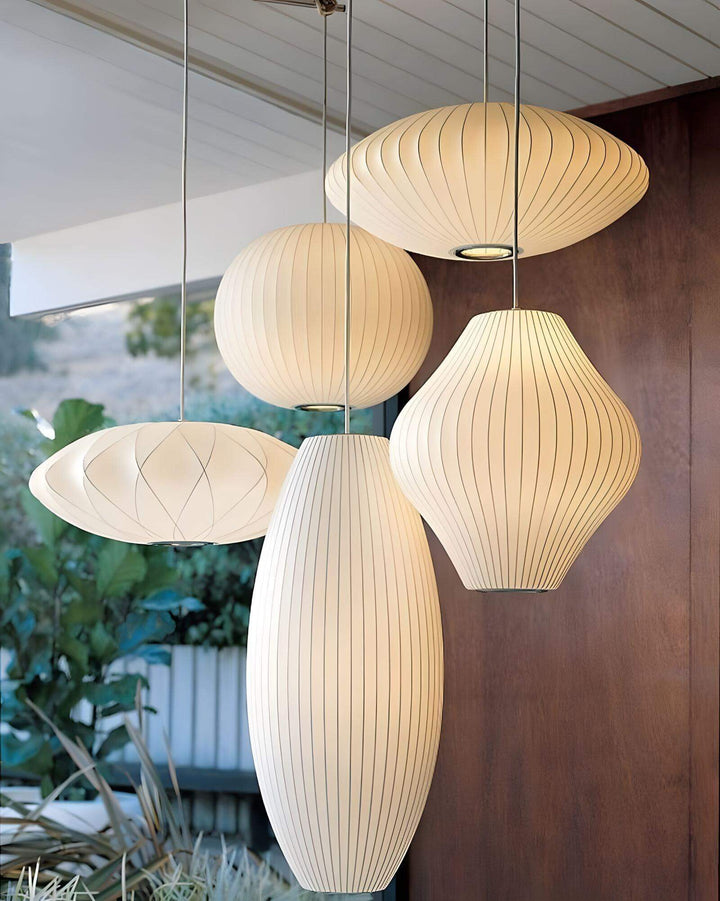 Cluster of five glowing Nelson Bubble pendant lights in sculptural globe, saucer, oval and hourglass shapes