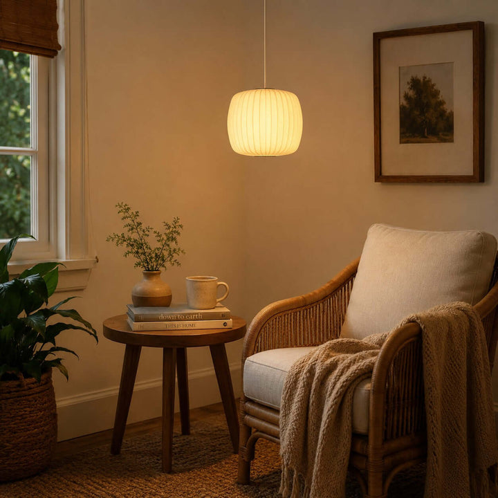 Rounded Nelson Bubble pendant lamp illuminating a rattan reading chair and small wood side table