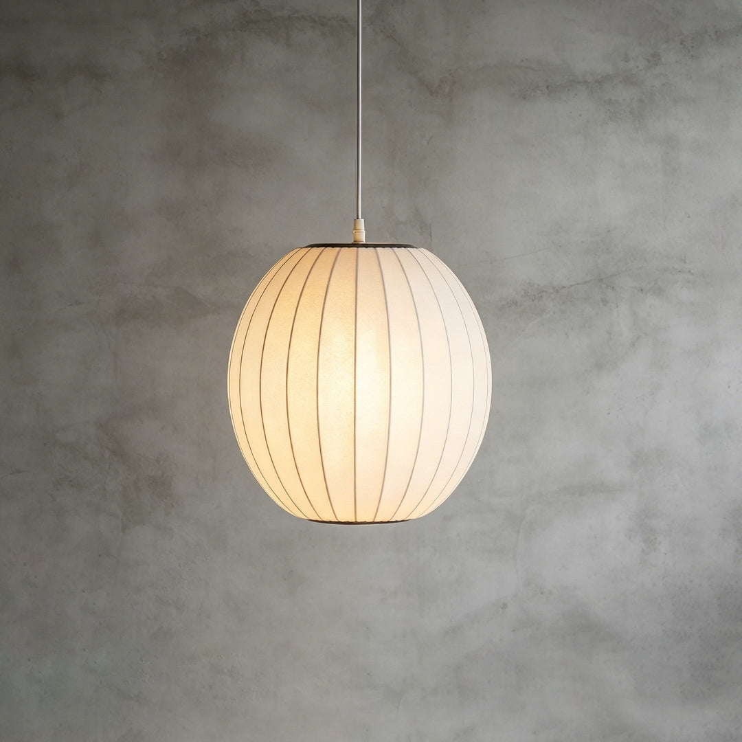 Rounded oval Nelson Bubble pendant lamp with a white ribbed shade against a textured concrete wall