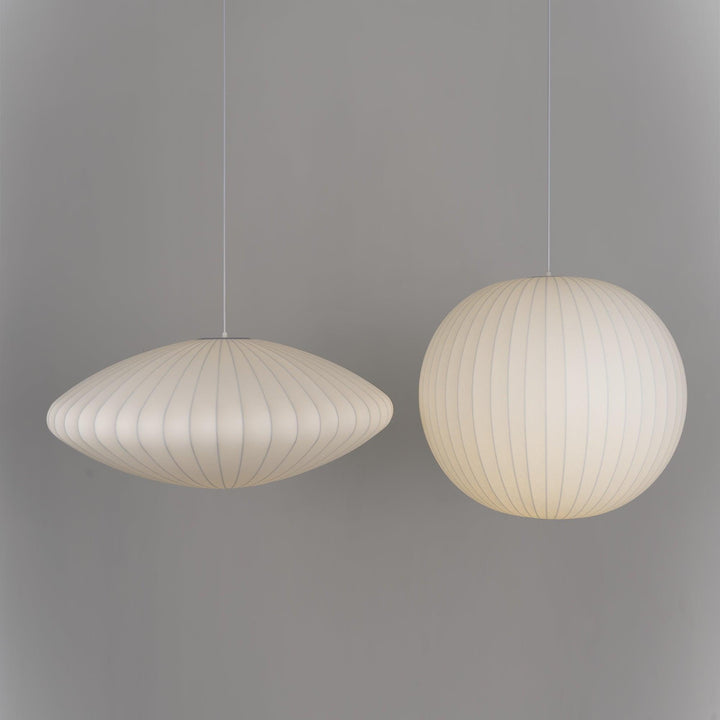 Saucer and globe Nelson Bubble pendant lights displayed together against a neutral gray wall