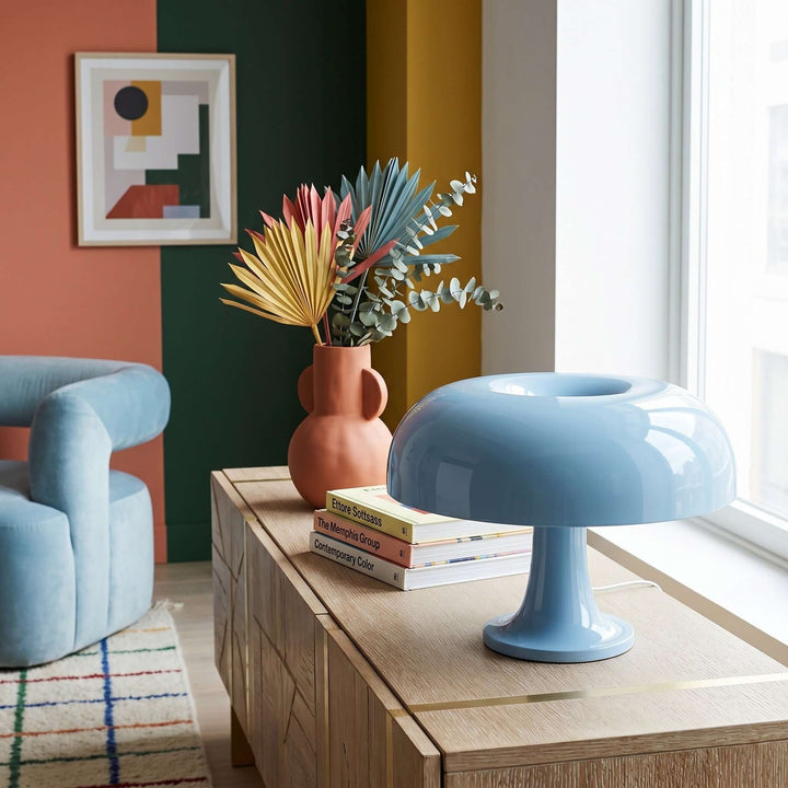Light blue Nesso Table Lamp on a console in a colorful modern living room