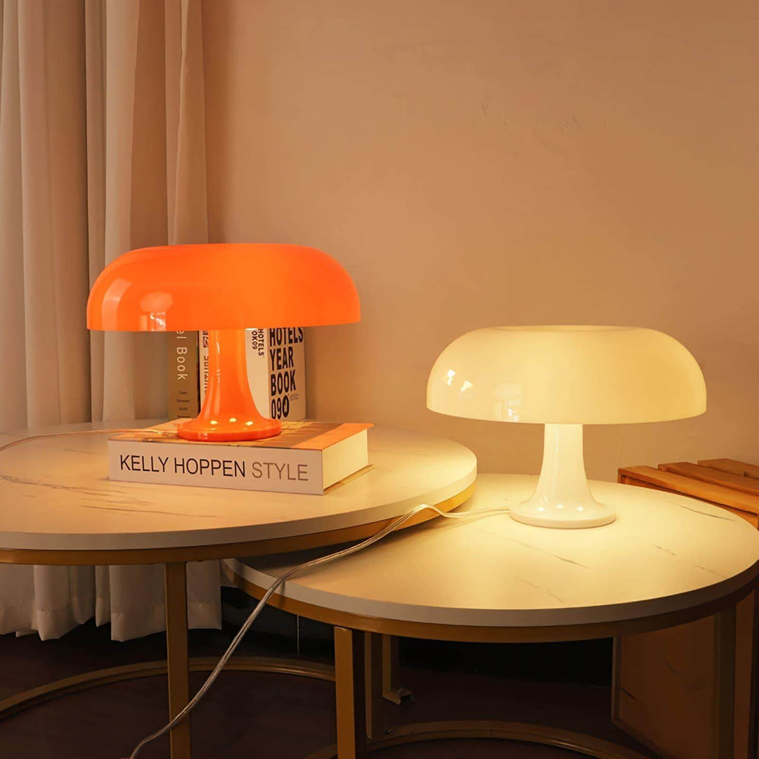 Orange and white Nesso Table Lamps glowing on two round side tables