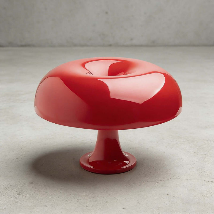 Red Nesso Table Lamp with a glossy sculptural shade against a concrete background