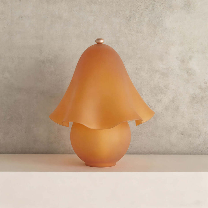Smooth frosted amber glass table lamp with softly curved flower shade and round base