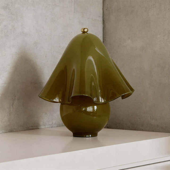 Smooth green glass table lamp with flowing flower shade and rounded base