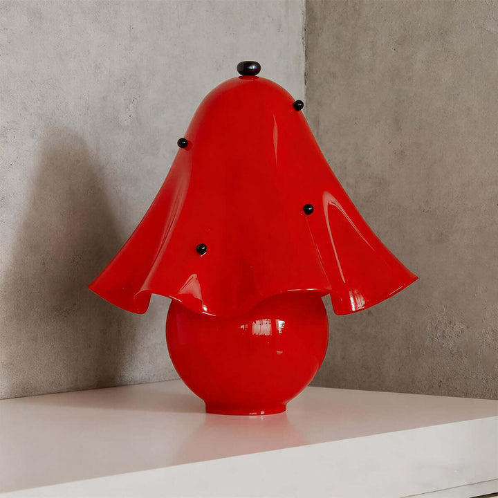 Spotted red glass table lamp with bold flower shade and contrasting black accents