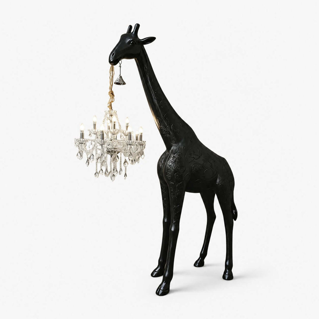 Nuvexa black giraffe floor lamp holding an illuminated silver crystal chandelier