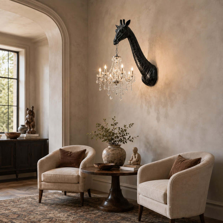 Black and silver Nuvexa giraffe wall lamp illuminating a refined sitting area with two accent chairs