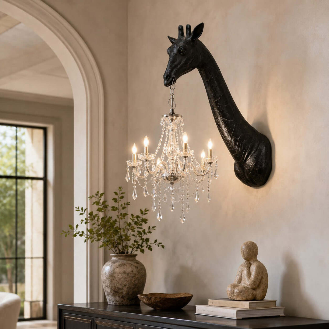 Black and silver Nuvexa Giraffe Wall Lamp with a crystal chandelier displayed above a dark wood console