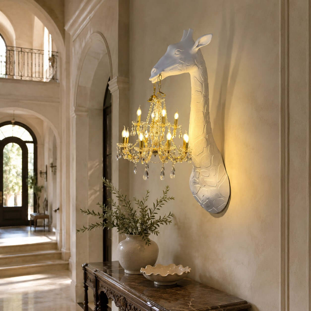 Nuvexa Giraffe Wall Lamp with a gold crystal chandelier displayed above a carved console in a luxury foyer