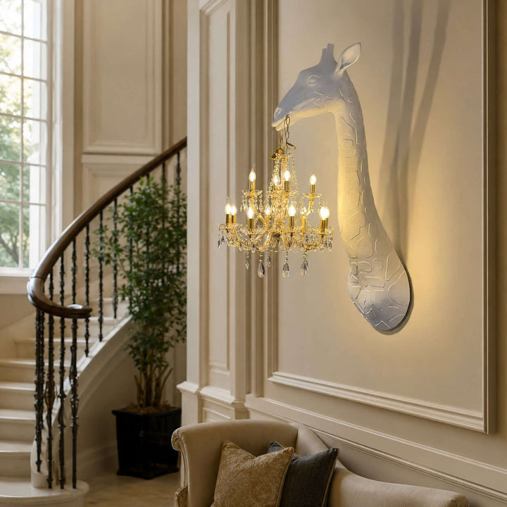 Nuvexa white and gold giraffe wall sconce installed beside a curved staircase and lounge chair