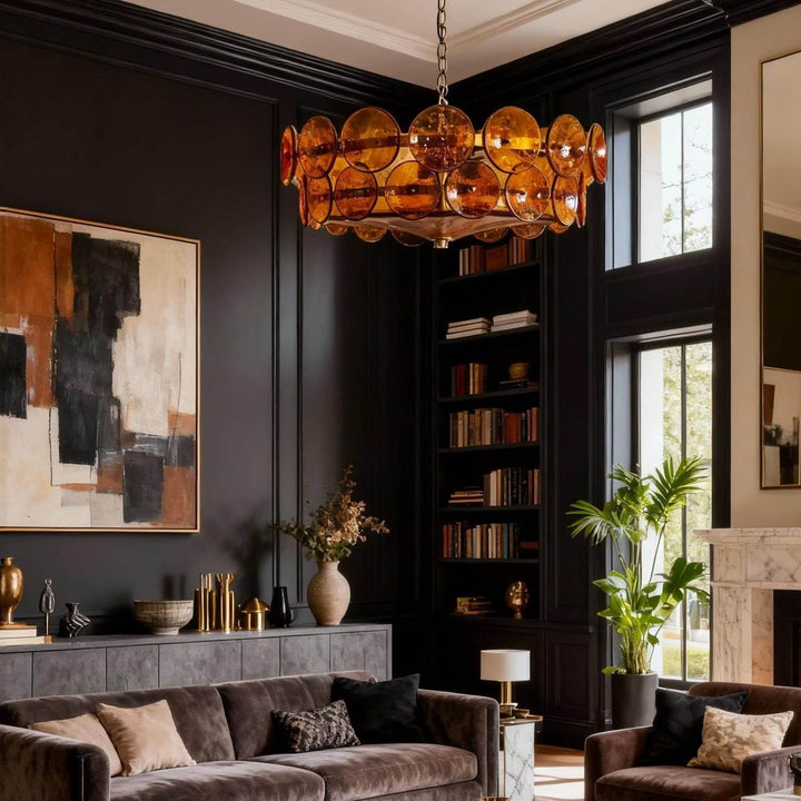 Orange glass chandelier creating a warm focal point in a dark modern living room