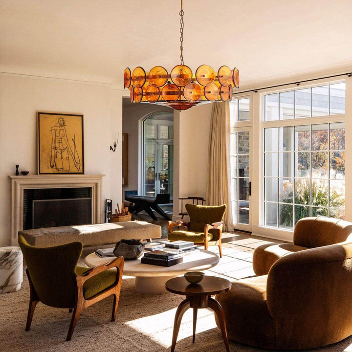 Orange glass chandelier hanging in a sunlit mid-century modern living room