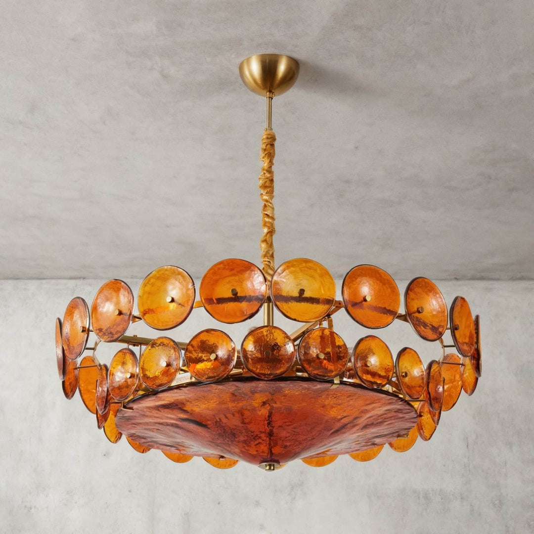 Low-angle detail of the Lorenzo orange glass chandelier and curved glass diffuser