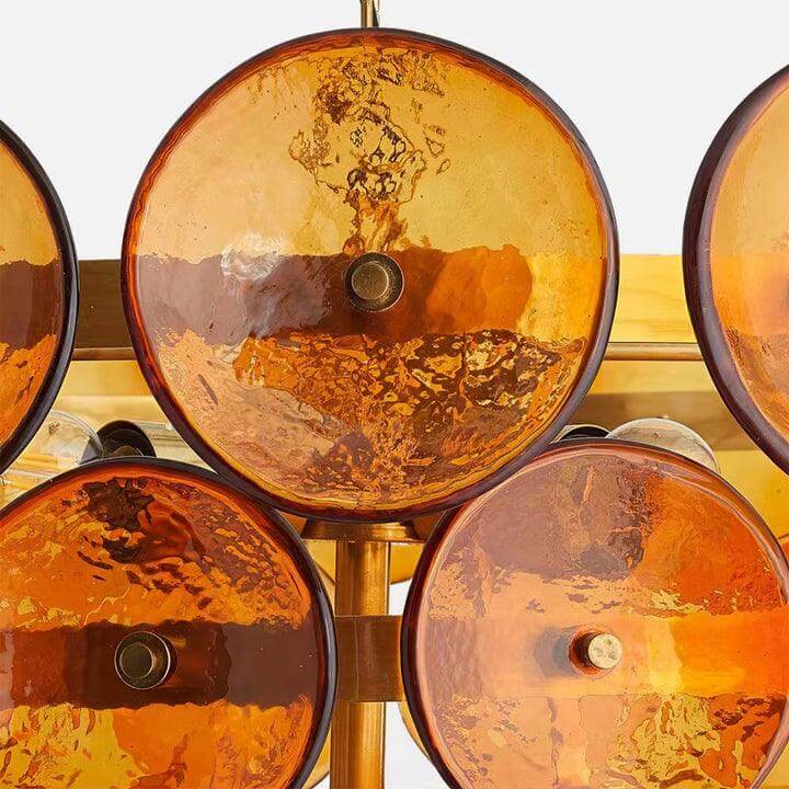 Close-up of orange textured glass discs and bronze-finish mounting hardware