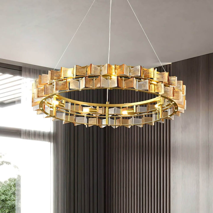Amber Orvex round chandelier with illuminated textured glass panels against a dark wood wall