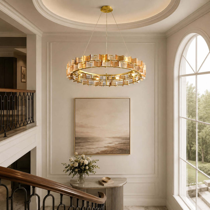 Amber Orvex round chandelier suspended above a stair landing with an arched window