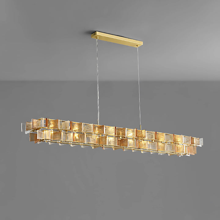 Amber Orvex linear chandelier shown from an angled side view on a gray background