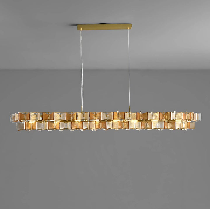 Amber Orvex linear chandelier with layered glass panels on a gray background