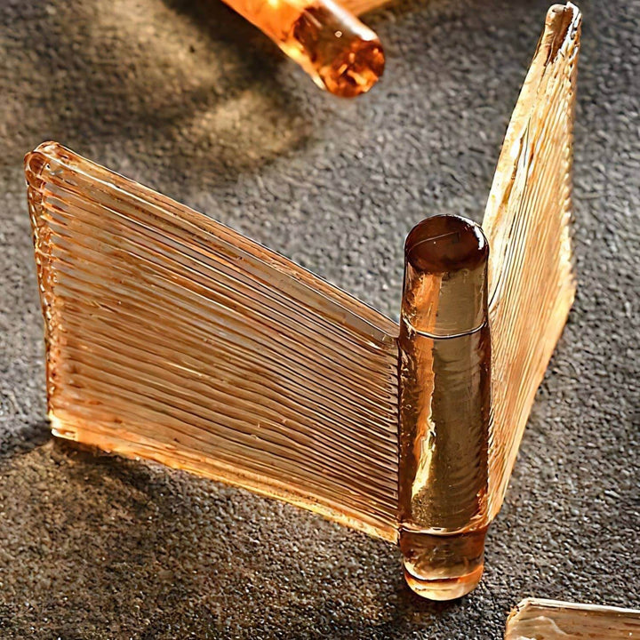 Close-up of an amber folded ribbed glass panel used on the Orvex chandelier