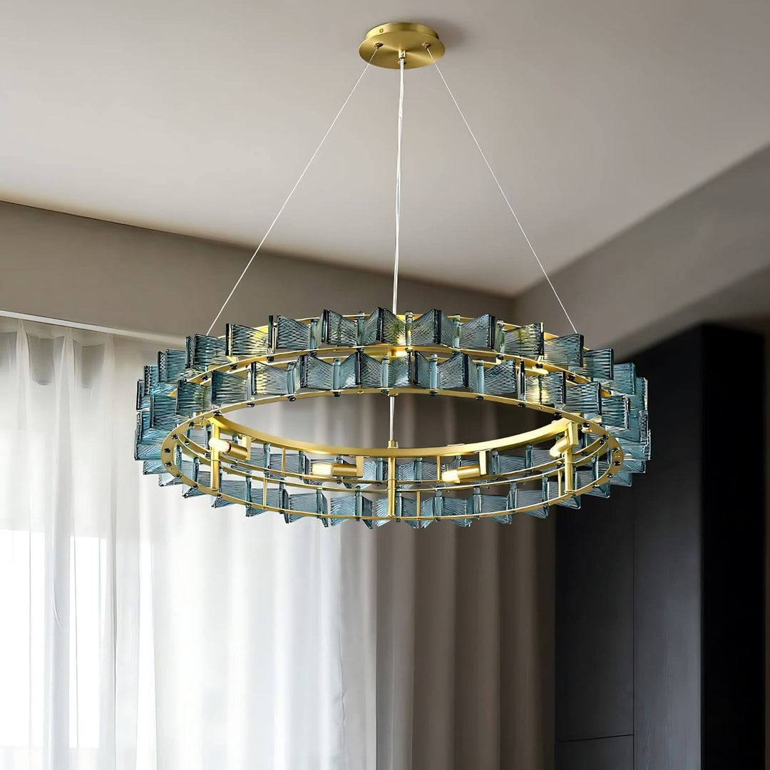 Blue Orvex round chandelier shown from an angled view in a bright contemporary room
