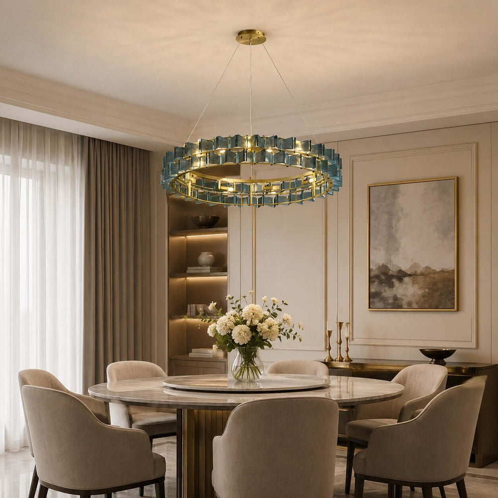 Blue Orvex dining room chandelier above a round marble table in a bright elegant interior