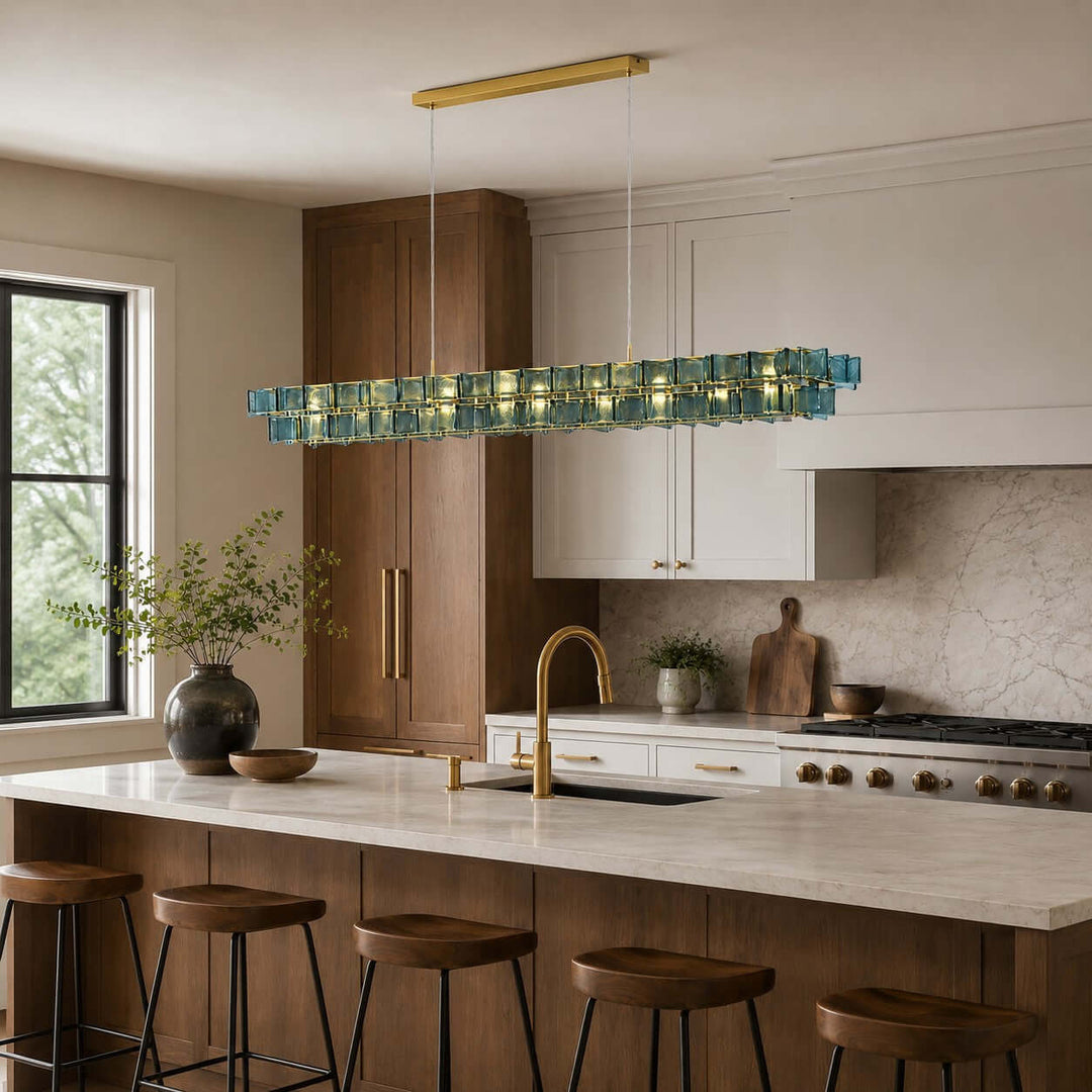 Blue Orvex linear chandelier with textured glass panels above a modern kitchen island