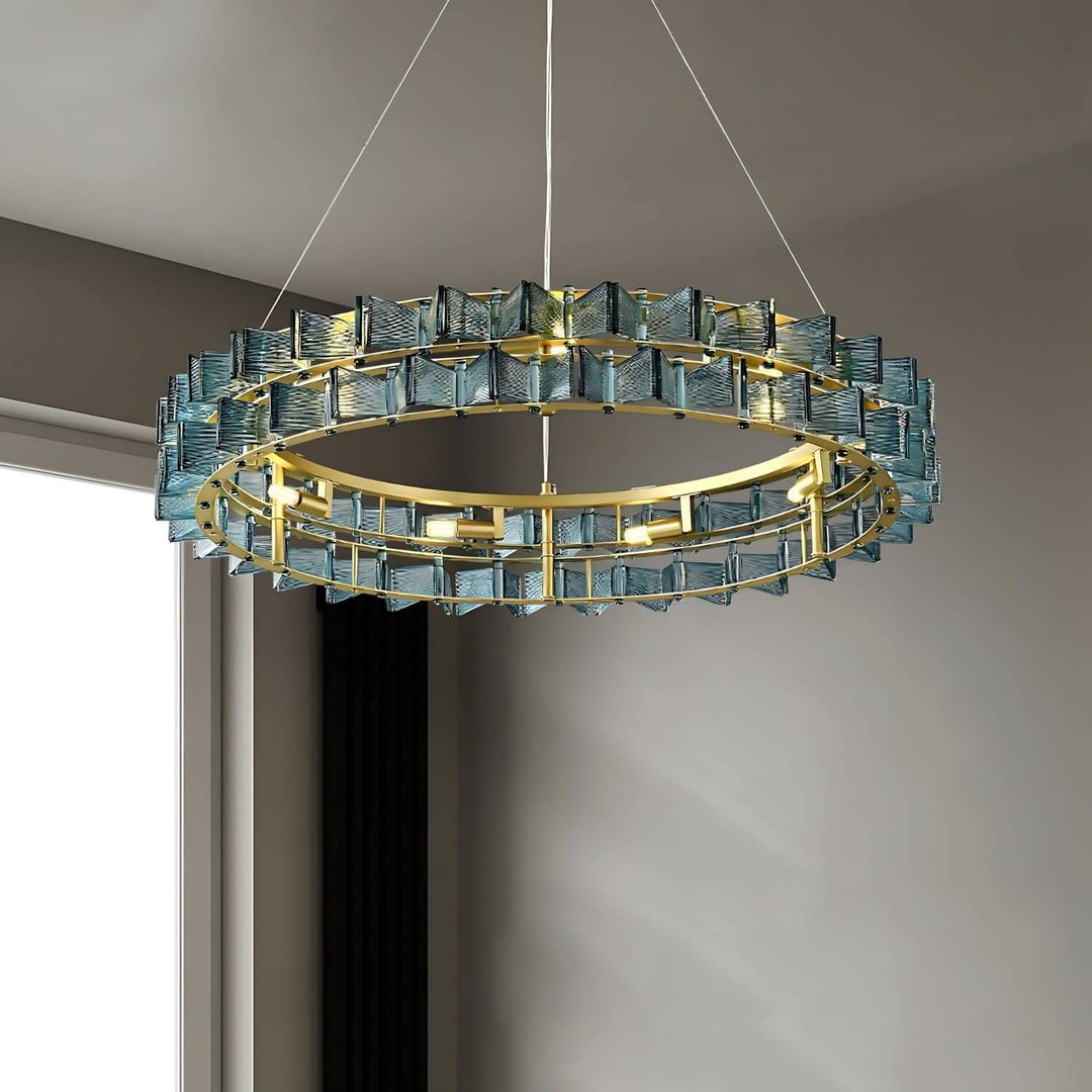 Front close-up of the blue Orvex round chandelier with a brushed gold circular frame