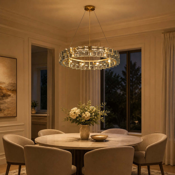 Orvex round chandelier with textured glass panels glowing above a dining table at night