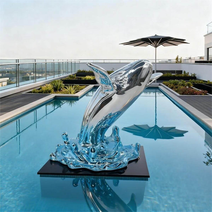 Outdoor whale sculpture installed on a pedestal in a rooftop swimming pool with city views.