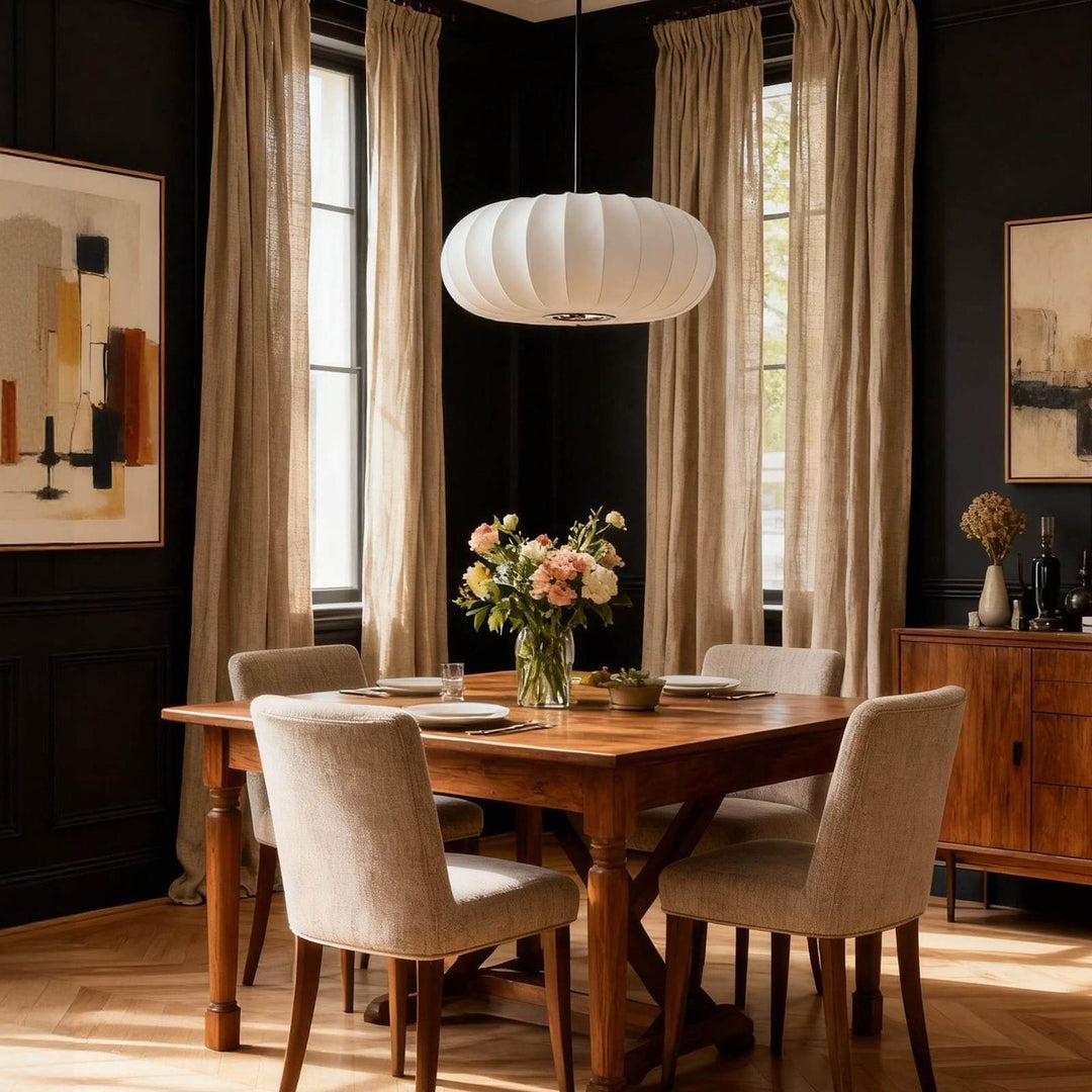 Oval silk dining pendant light above a wooden table in a dark modern dining room