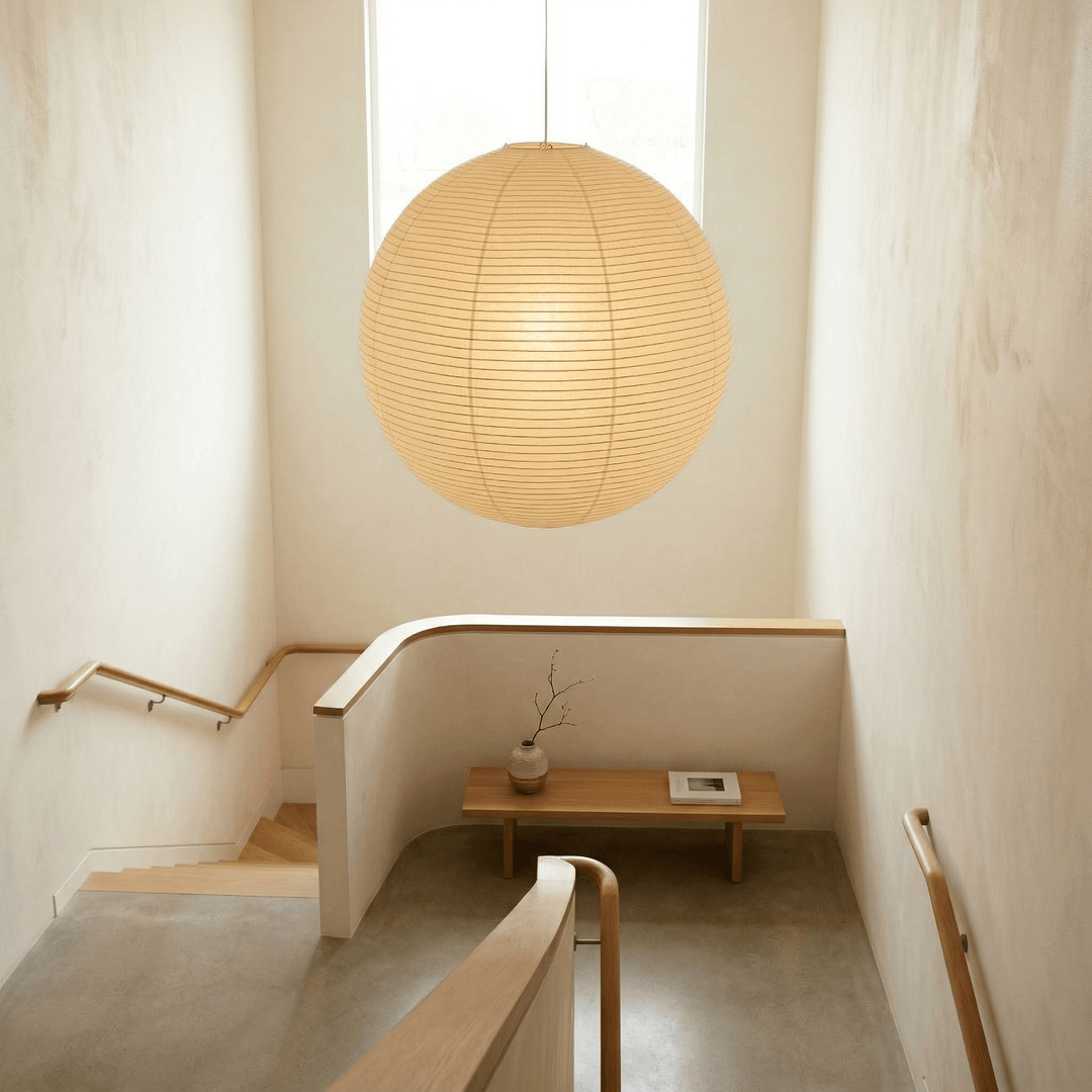 Oversized washi paper globe pendant light in a bright stairwell