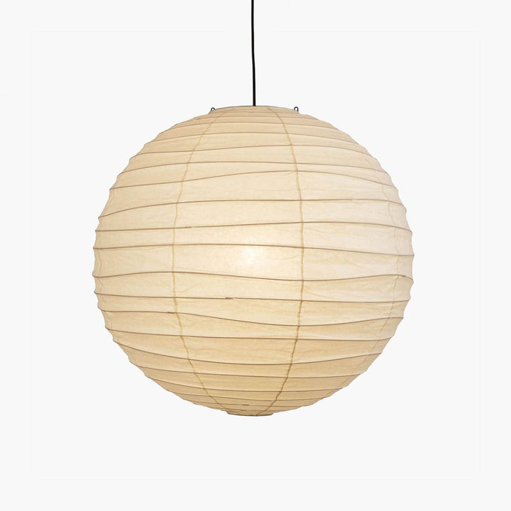 Close-up paper lantern pendant light with black cord shown lit on a plain white background.