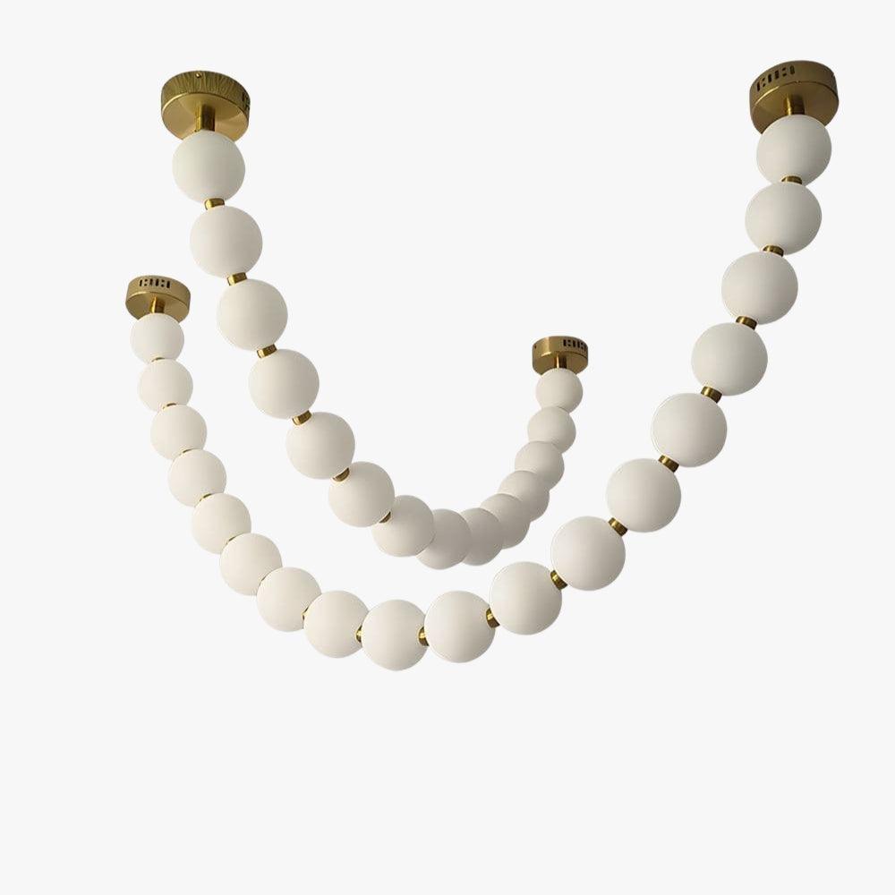 Pearl necklace chandelier with white globe strands and gold ceiling canopies on a plain background.