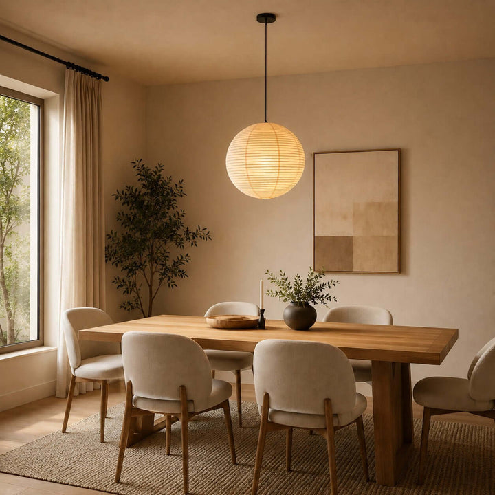 Round rice paper pendant light above a rectangular wood dining table