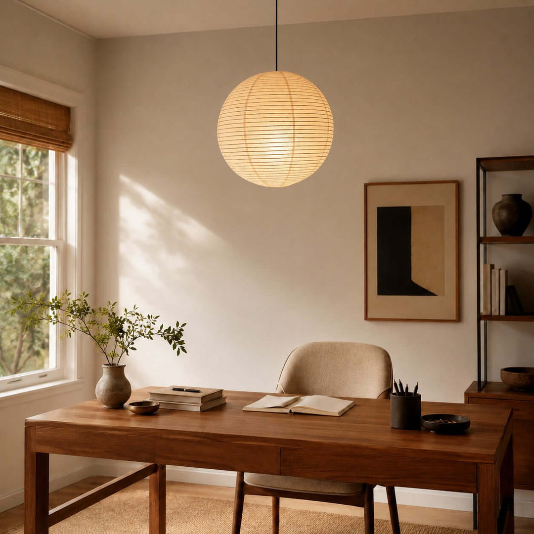 Round rice paper pendant light above a wooden home office desk