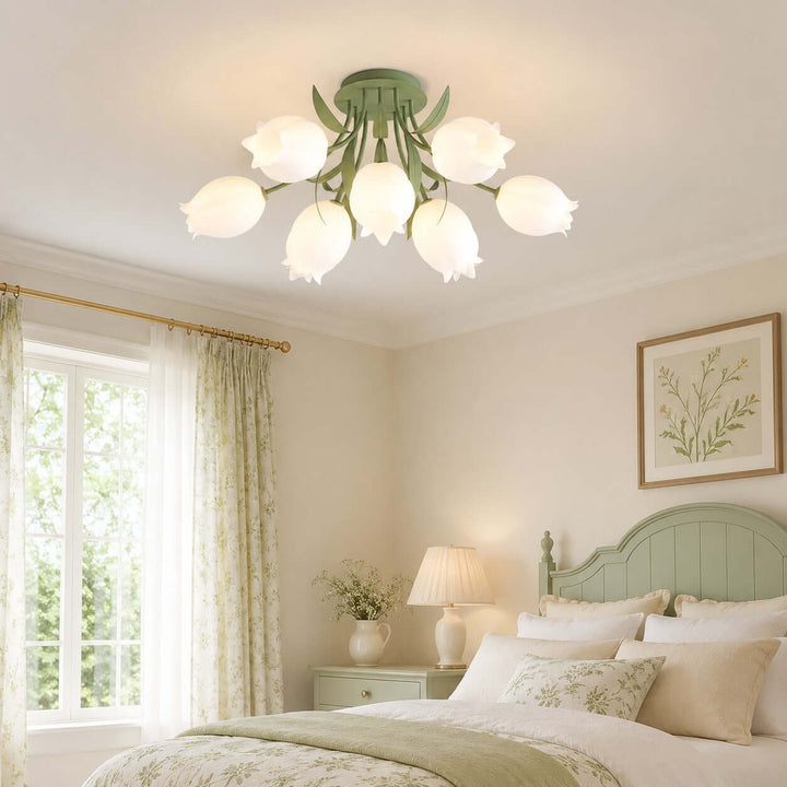 Ricko green flower ceiling light above a soft cottage bedroom with a sage headboard and floral curtains.