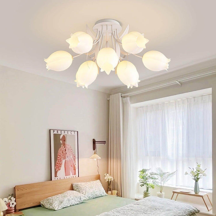 Ricko white flower ceiling light glowing above a bright bedroom with a wood bed and large window.