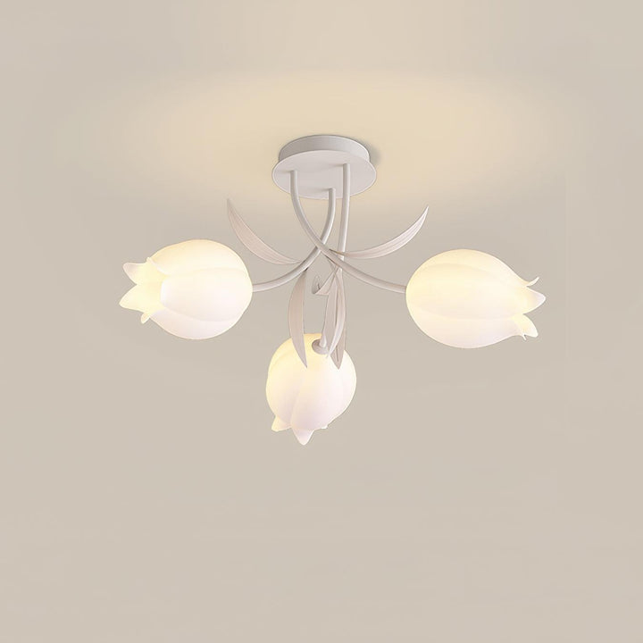Three-light Ricko white ceiling fixture with glowing cream flower shades on a neutral background.