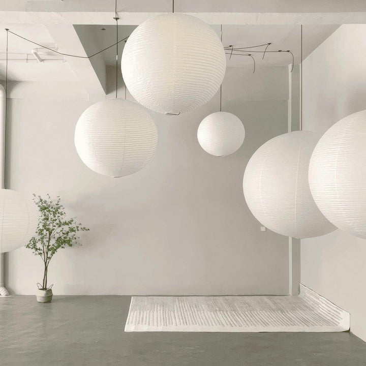 Cluster of round white paper lantern pendant lights in multiple sizes