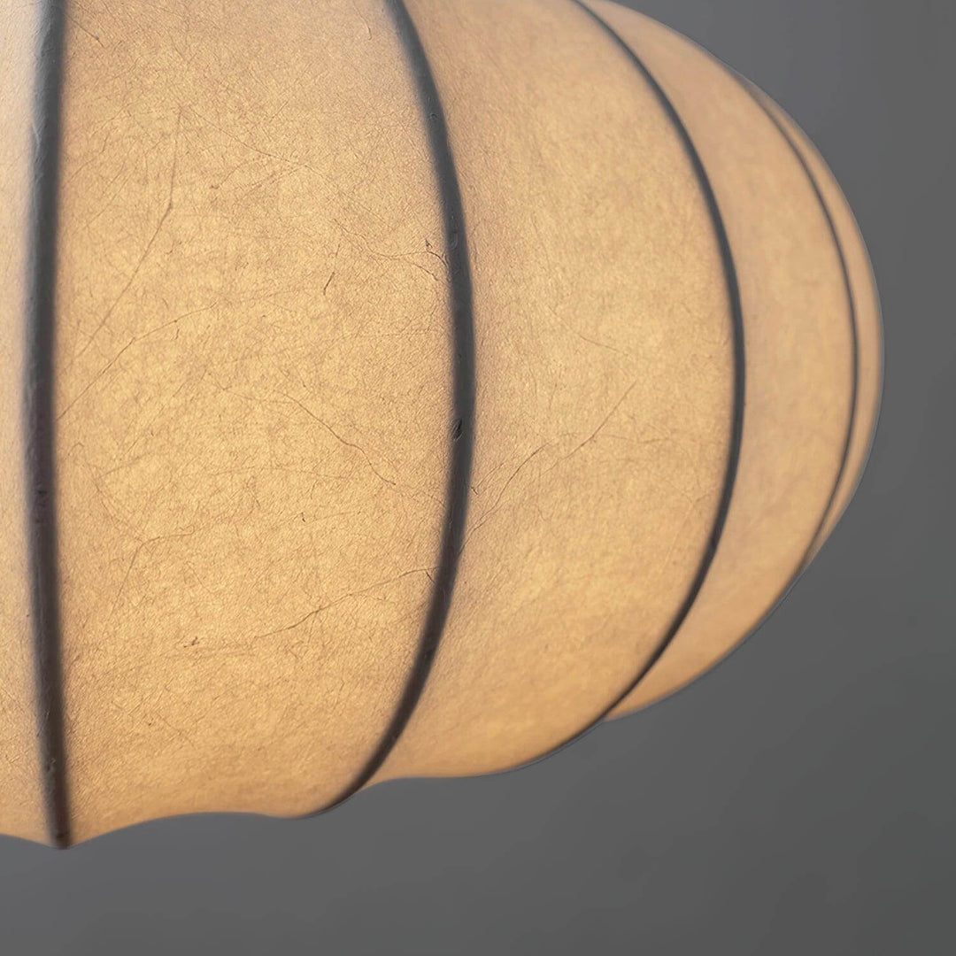 Close-up of the illuminated silk fabric and ribbed frame on the Verona pendant shade