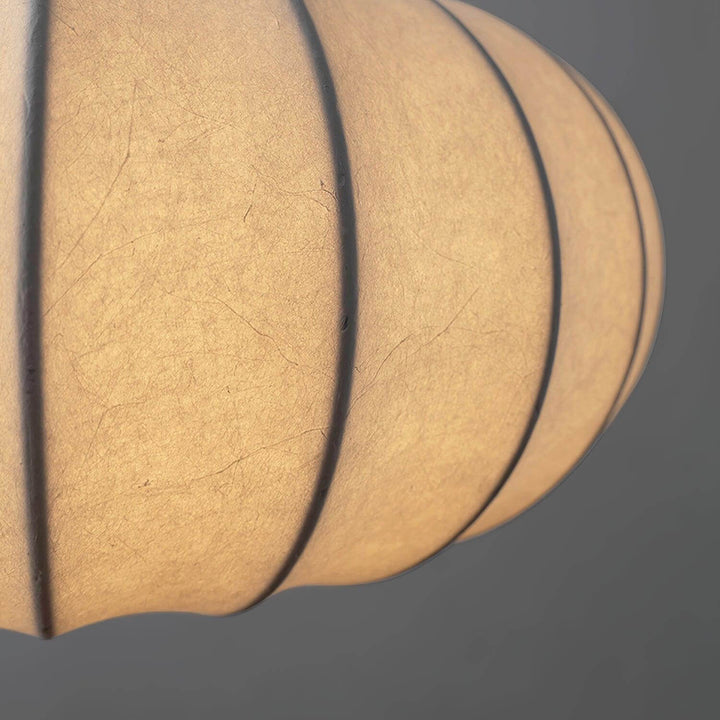 Close-up of the illuminated silk fabric and ribbed frame on the Verona pendant shade
