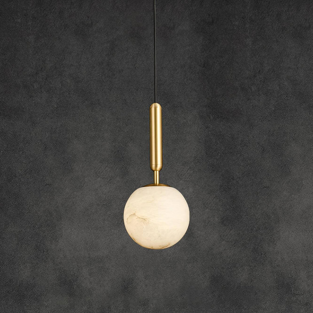 Small brass and alabaster globe pendant light displayed against a dark textured background