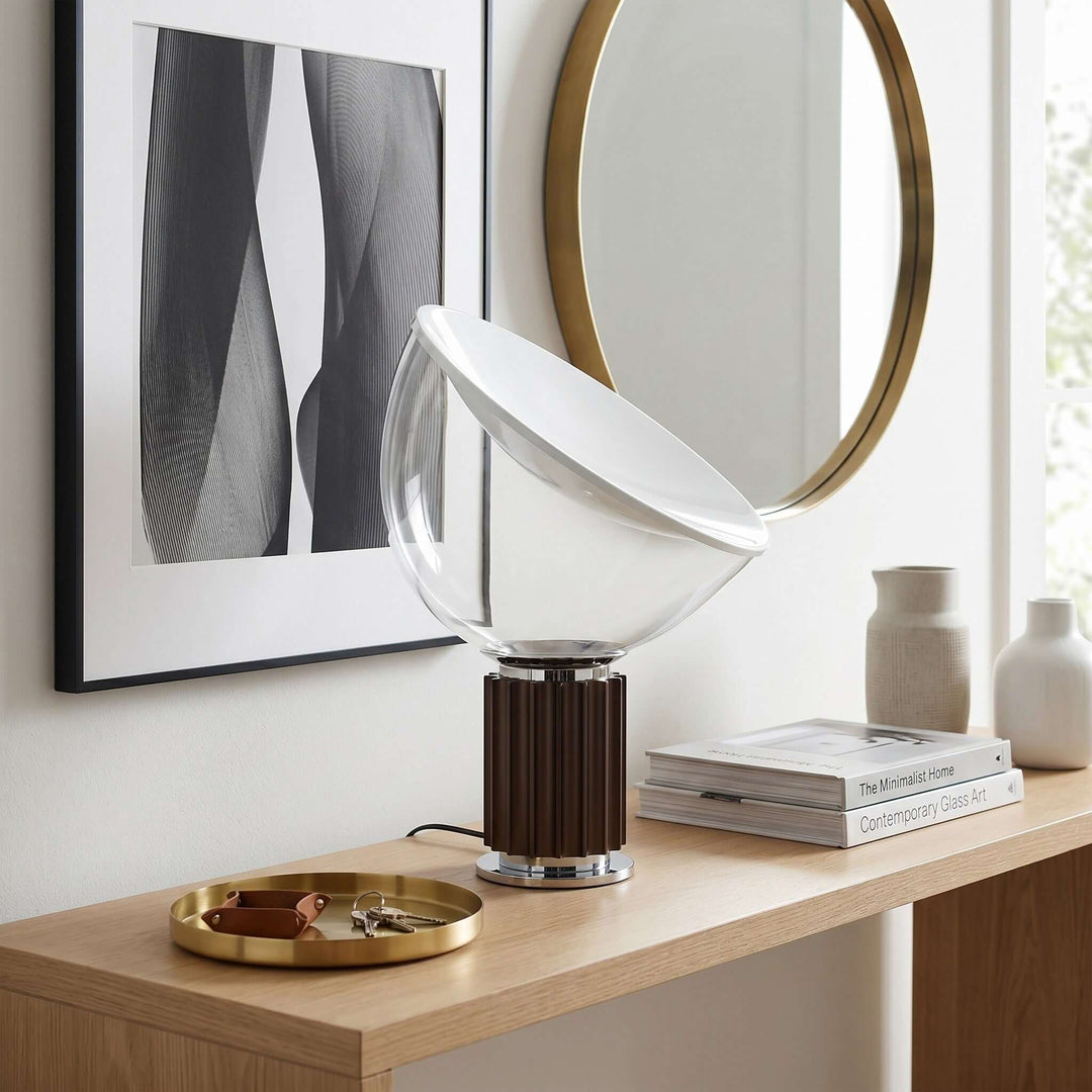 Coffee-brown Taccia table lamp on a wood entryway console beneath a round mirror and abstract artwork