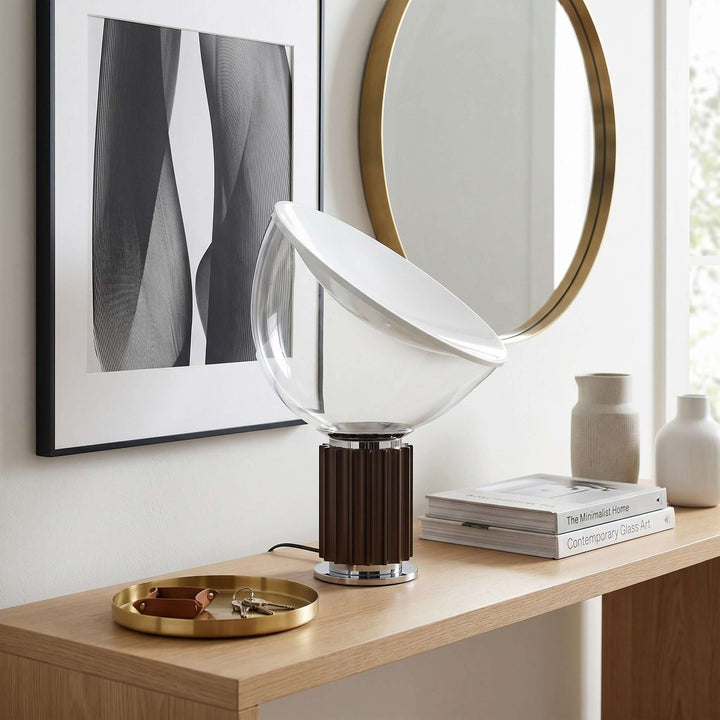 Coffee-brown Taccia table lamp on a wood entryway console beneath a round mirror and abstract artwork
